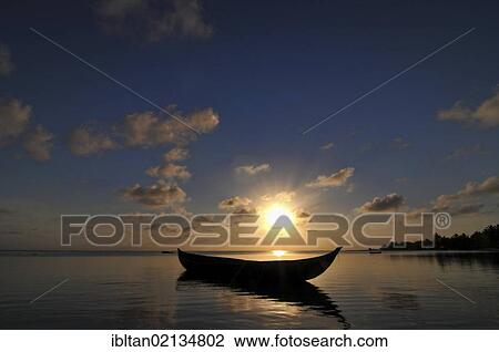 Stock Image - Traditional Malagasy boat near the beach at sunset, Madagascar, Africa. Fotosearch