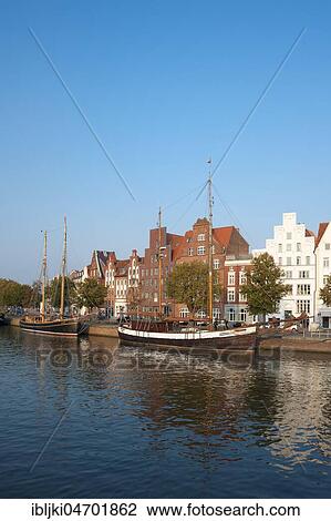 Stock Image - Traditional sailing boat on the Untertrave, Historic Houses, Lübeck, Schleswig-Holstein, Germany, Europe. Fotosearch