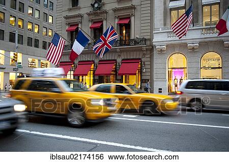 Traffic at dusk, Cartier and Versace shops at back, yellow cabs, taxis, 5th Avenue, Midtown, Manhattan New York City, USA, North America, America, North America View Large Photo Image Stock Photograph - Traffic at dusk, Cartier and Versace shops at back, yellow cabs, taxis, 5th Avenue, Midtown, Manhattan New York City, USA, North America, America, North America. Fotosearch