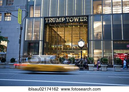 Stock Image - Traffic at dusk, yellow cab, taxi, motion blur, in front of the entrance to Trump Tower, 5th Avenue, Midtown, Manhattan, New York City, USA, North America, America, North America. Fotosearch