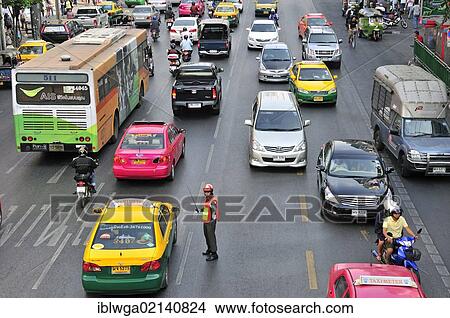 Traffic with a traffic policeman, Phetburi Road, Bangkok, Thailand, Asia, PublicGround, Asia View Large Photo Image Picture - Traffic with a traffic policeman, Phetburi Road, Bangkok, Thailand, Asia, PublicGround, Asia. Fotosearch