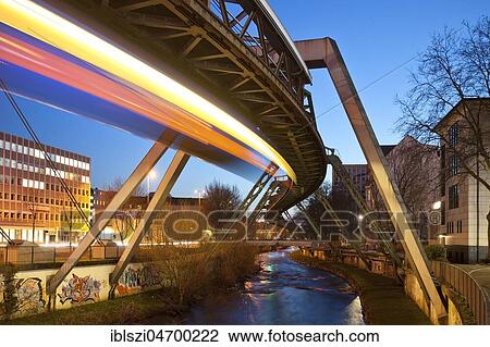 Trail of light from a moving suspension railway above the Wupper, Wuppertal, Bergisches Land, North Rhine-Westphalia, Germany, Europe View Large Photo Image Stock Image - Trail of light from a moving suspension railway above the Wupper, Wuppertal, Bergisches Land, North Rhine-Westphalia, Germany, Europe. Fotosearch