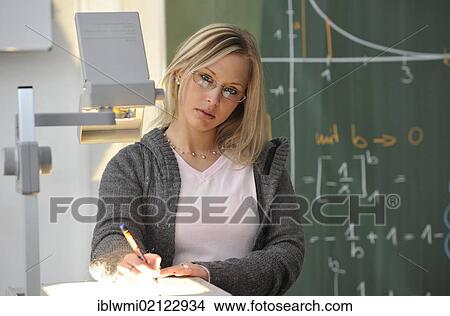Picture - Trainee teacher, prospective teacher, young teacher, mathematics, blackboard, classroom, overhead projector, Baden-Wuerttemberg, Germany, Europe. Fotosearch