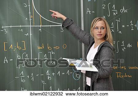 Stock Image - Trainee teacher, prospective teacher, young teacher, mathematics, blackboard, classroom, Baden-Wuerttemberg, Germany, Europe. Fotosearch