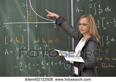 Stock Photo - Trainee teacher, prospective teacher, young teacher, mathematics, blackboard, classroom, Baden-Wuerttemberg, Germany, Europe. Fotosearch