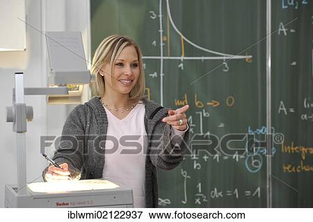 Trainee teacher, prospective teacher, young teacher, mathematics, blackboard, classroom, overhead projector, Baden-Wuerttemberg, Germany, Europe View Large Photo Image Stock Photo - Trainee teacher, prospective teacher, young teacher, mathematics, blackboard, classroom, overhead projector, Baden-Wuerttemberg, Germany, Europe. Fotosearch