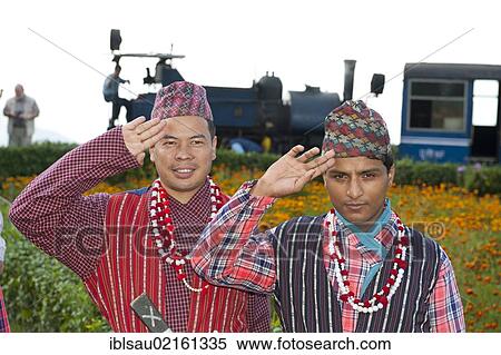 Two Nepali men in traditional costume saluting, historic train at back, Darjeeling Himalayan Railway, narrow-gauge railway, Toy Train, UNESCO World Heritage Site, Darjeeling, West Bengal, India, South Asia, Asia View Large Photo Image Stock Photography - Two Nepali men in traditional costume saluting, historic train at back, Darjeeling Himalayan Railway, narrow-gauge railway, Toy Train, UNESCO World Heritage Site, Darjeeling, West Bengal, India, South Asia, Asia. Fotosearch