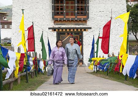 Two women dressed in traditional costume, coloured flags lining a path, fortress-monastery, Dzong, Punakha, the Himalayas, Kingdom of Bhutan, South Asia, Asia View Large Photo Image Stock Image - Two women dressed in traditional costume, coloured flags lining a path, fortress-monastery, Dzong, Punakha, the Himalayas, Kingdom of Bhutan, South Asia, Asia. Fotosearch