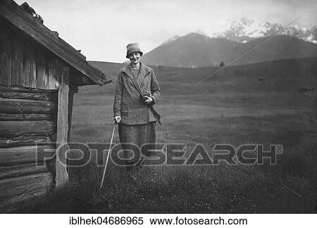 Vacation, woman with walking stick hiking in the Alps, 1920s, Bavaria, Germany, Europe View Large Photo Image Stock Photography - Vacation, woman with walking stick hiking in the Alps, 1920s, Bavaria, Germany, Europe. Fotosearch