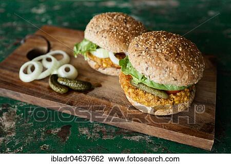 Vegan burgers with corn pattie, pickles and onions, food still-life, studio shot View Large Photo Image Stock Image - Vegan burgers with corn pattie, pickles and onions, food still-life, studio shot. Fotosearch