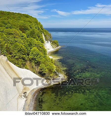 View from the high bank to the Baltic Sea and the chalk cliffs in spring, fresh green, Jasmund National Park, Rügen Island, Mecklenburg-Western Pomerania, Germany, Europe View Large Photo Image Stock Image - View from the high bank to the Baltic Sea and the chalk cliffs in spring, fresh green, Jasmund National Park, Rügen Island, Mecklenburg-Western Pomerania, Germany, Europe. Fotosearch