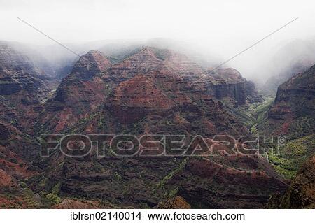 Picture - Waimea Canyon under low-hanging clouds on the island of Kaua'i, Waimea, Hawai'i, USA, North America. Fotosearch