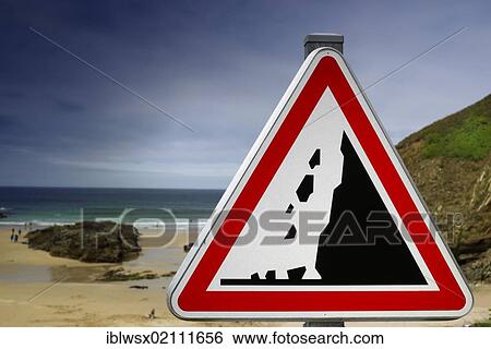 Stock Photograph - Warning sign, caution falling rocks on the Atlantic beach, Finistere, Brittany, France, Europe, PublicGround, Europe. Fotosearch
