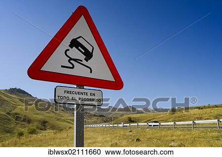 Stock Image - Warning sign, slippery road, on the mountain pass road to El Portalet, border ridge between the regions of Aragon and the French department of Hautes-Pyrénées, Spain, Europe, PublicGround, Europe. Fotosearch