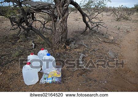 Water and food for Mexican migrants left along a desert trail by volunteers with No More Deaths, a faith-based group with the goal is to reduce the death toll among migrants who cross the desert to find work in the United States; more than 5, 000 have... View Large Photo Image Stock Image - Water and food for Mexican migrants left along a desert trail by volunteers with No More Deaths, a faith-based group with the goal is to reduce the death toll among migrants who cross the desert to find work in the United States; more than 5, 000 have.... Fotosearch