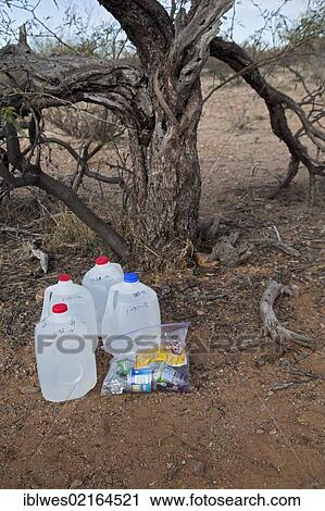 Water and food for Mexican migrants left along a desert trail by volunteers with No More Deaths, a faith-based group with the goal is to reduce the death toll among migrants who cross the desert to find work in the United States; more than 5, 000 have... View Large Photo Image Stock Image - Water and food for Mexican migrants left along a desert trail by volunteers with No More Deaths, a faith-based group with the goal is to reduce the death toll among migrants who cross the desert to find work in the United States; more than 5, 000 have.... Fotosearch