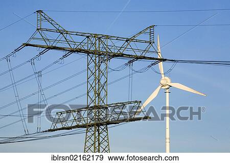 Stock Photo - Wind turbine and electricity pylon of the Uckermark power plant, electricity generated regionally through wind energy by ENERTRAG AG is fed into the 220-kV grid of Vattenfall Europe Transmission GmbH, Bertikow, Brandenburg, Germany, Europe. Fotosearch