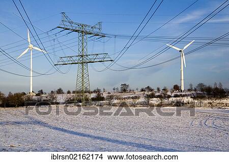 Wind turbines and electricity pylons of Uckermark power plant in a wintry landscape, electricity generated regionally through wind energy by ENERTRAG AG is fed into the 220-kV grid of Vattenfall Europe Transmission GmbH, Bertikow, Brandenburg,... View Large Photo Image Picture - Wind turbines and electricity pylons of Uckermark power plant in a wintry landscape, electricity generated regionally through wind energy by ENERTRAG AG is fed into the 220-kV grid of Vattenfall Europe Transmission GmbH, Bertikow, Brandenburg,.... Fotosearch