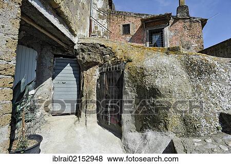 Winding alley with stairways and passages, medieval town of Vecchia Calcata, valley of Valle del Treja, Lazio, Italy, Europe View Large Photo Image Stock Photo - Winding alley with stairways and passages, medieval town of Vecchia Calcata, valley of Valle del Treja, Lazio, Italy, Europe. Fotosearch