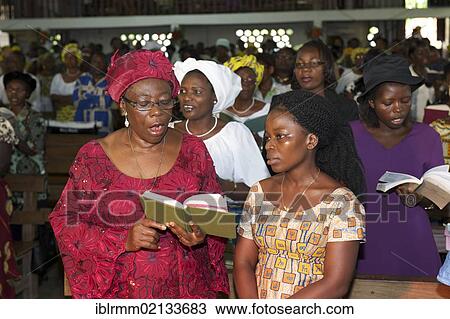 Stock Image - Woman at Sunday service at the Presbyterian Church, Lime, Cameroon, Africa. Fotosearch