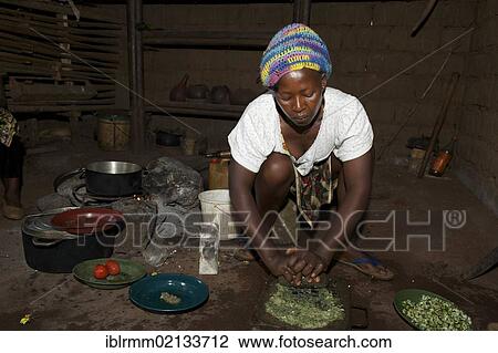 Stock Image - Woman cooking in a kitchen, Bamenda, Cameroon, Africa. Fotosearch