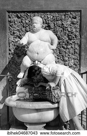 Woman drinking from a fountain, 1950s, Germany, Europe View Large Photo Image Stock Image - Woman drinking from a fountain, 1950s, Germany, Europe. Fotosearch