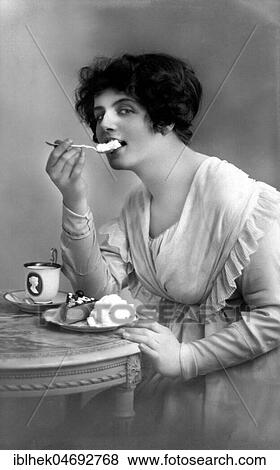 Woman eating cake with cream, 1910s, Germany, Europe View Large Photo Image Stock Photo - Woman eating cake with cream, 1910s, Germany, Europe. Fotosearch