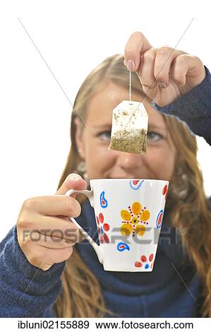 Stock Photo - Woman preparing tea with a tea bag. Fotosearch