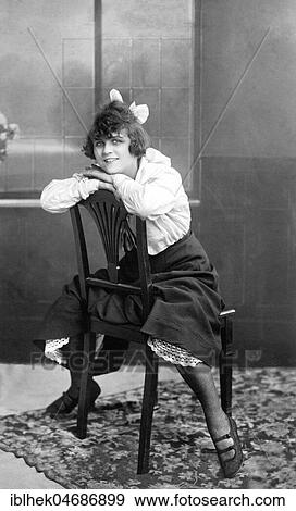 Woman sitting on a chair with her legs apart, 1920s, Germany, Europe View Large Photo Image Stock Photo - Woman sitting on a chair with her legs apart, 1920s, Germany, Europe. Fotosearch
