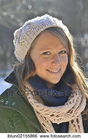 Woman wearing a hat and a scarf, outdoors, in winter View Large Photo Image Stock Photograph - Woman wearing a hat and a scarf, outdoors, in winter. Fotosearch