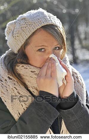 Woman wearing a hat and a scarf, outdoors, in winter, blowing her nose View Large Photo Image Stock Photography - Woman wearing a hat and a scarf, outdoors, in winter, blowing her nose. Fotosearch