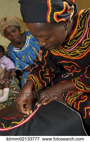Stock Photo - Woman wearing traditional dress doing embroidery work, Bamenda, Cameroon, Africa. Fotosearch