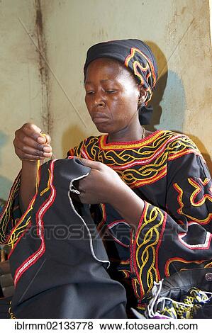 Woman wearing traditional dress doing embroidery work, Bamenda, Cameroon, Africa View Large Photo Image Stock Photo - Woman wearing traditional dress doing embroidery work, Bamenda, Cameroon, Africa. Fotosearch