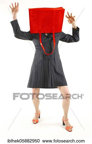 Stock Image - Woman with handbag over her head, Berlin, Germany, Europe. Fotosearch