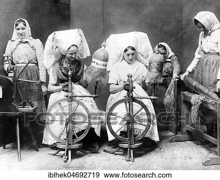 Stock Photo - Women in traditional traditional costume spinning flax, 1920s, Spreewald, Germany, Europe. Fotosearch