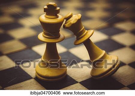 Stock Photograph - Wooden chess pieces, queen defeats king. Fotosearch