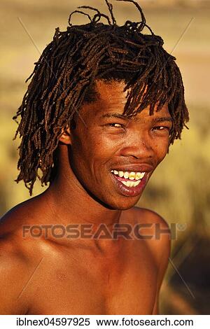 Stock Photography - Young bushman of the San people, portrait,! Xaus Lodge, Kalahari or Kglagadi Transfrontier Park, Northern Cape, South Africa, Africa. Fotosearch