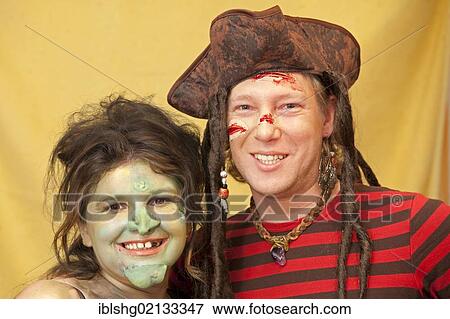 Stock Photo - Young couple in costume dressed as witch and pirate. Fotosearch