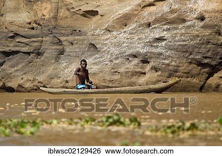 Young Malagasy in a dugout boat, Madagascar, Africa View Large Photo Image Stock Photograph - Young Malagasy in a dugout boat, Madagascar, Africa. Fotosearch