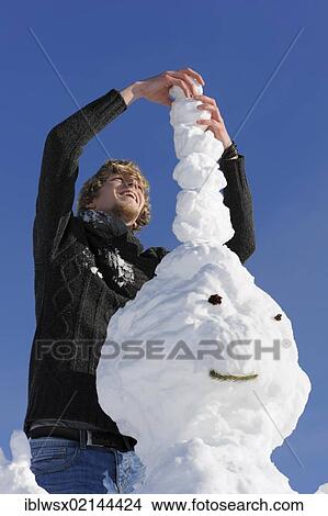 Young man building a snowman, Black Forest, Baden-Wuerttemberg, Germany, Europe, PublicGround, Europe View Large Photo Image Picture - Young man building a snowman, Black Forest, Baden-Wuerttemberg, Germany, Europe, PublicGround, Europe. Fotosearch