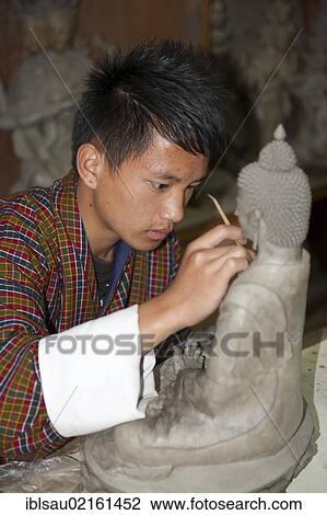 Young man training to become a sculptor, working very focused on a small Buddha statue, handicraft, National Institute of Zorig Chusum, Painting School, Hauptstadt Thimphu, Himalaja, Koenigreich Bhutan, South Asia, Asia View Large Photo Image Stock Image - Young man training to become a sculptor, working very focused on a small Buddha statue, handicraft, National Institute of Zorig Chusum, Painting School, Hauptstadt Thimphu, Himalaja, Koenigreich Bhutan, South Asia, Asia. Fotosearch