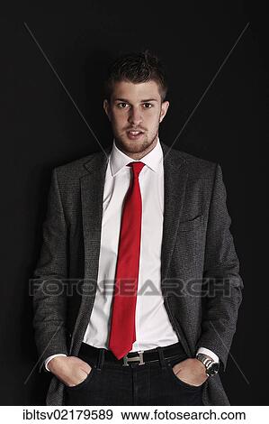 Young man wearing a suit, hands in pockets View Large Photo Image Stock Photo - Young man wearing a suit, hands in pockets. Fotosearch