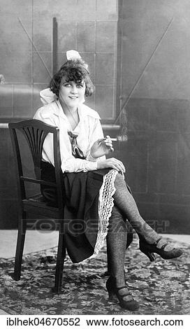 Young, pretty woman sitting on a chair smoking, 1920s, Germany, Europe View Large Photo Image Stock Image - Young, pretty woman sitting on a chair smoking, 1920s, Germany, Europe. Fotosearch