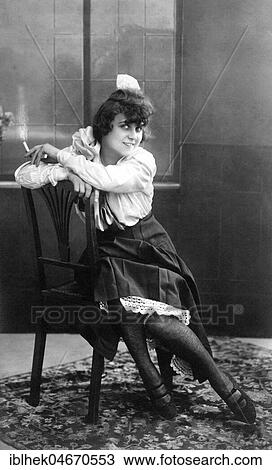 Young, pretty woman sitting on a chair smoking, 1920s, Germany, Europe View Large Photo Image Stock Image - Young, pretty woman sitting on a chair smoking, 1920s, Germany, Europe. Fotosearch