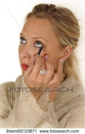 Young woman applying make-up, eyeliner View Large Photo Image Stock Image - Young woman applying make-up, eyeliner. Fotosearch