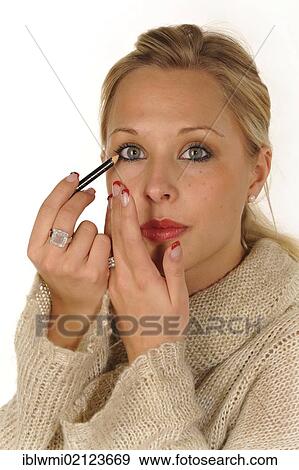 Young woman applying make-up, eyeliner View Large Photo Image Stock Photo - Young woman applying make-up, eyeliner. Fotosearch