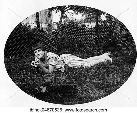Young woman lying in the grass smoking, 1920s, Germany, Europe View Large Photo Image Stock Photograph - Young woman lying in the grass smoking, 1920s, Germany, Europe. Fotosearch