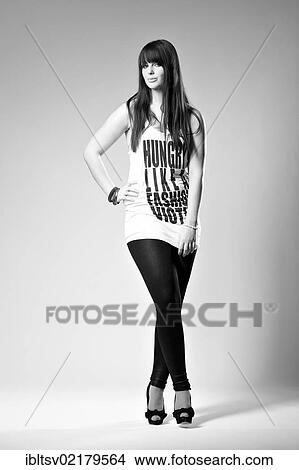 Picture - Young woman posing with shirt and leggings. Fotosearch