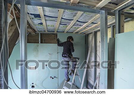 Young woman renovating the attic in an old house, Mecklenburg-Western Pomerania, Germany, Europe View Large Photo Image Stock Photograph - Young woman renovating the attic in an old house, Mecklenburg-Western Pomerania, Germany, Europe. Fotosearch