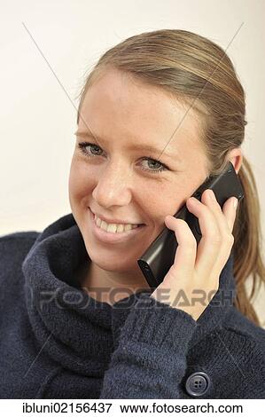 Young woman talking on a telephone View Large Photo Image Stock Photo - Young woman talking on a telephone. Fotosearch